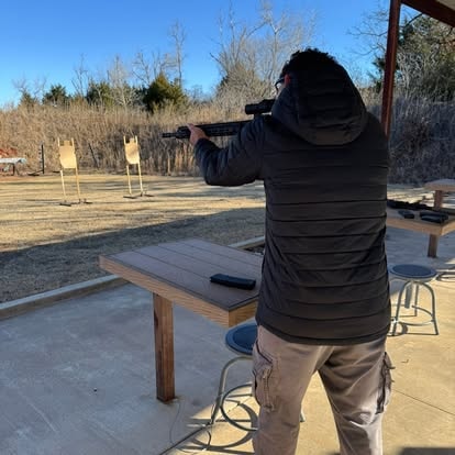 Shooter engaging paper targets at the outdoor range